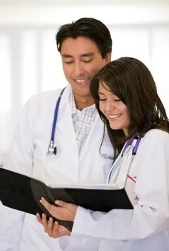 couple of doctors  looking at a history chart in a hospital