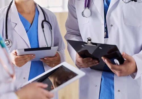 doctors-using-tablet-hospital-standing-office