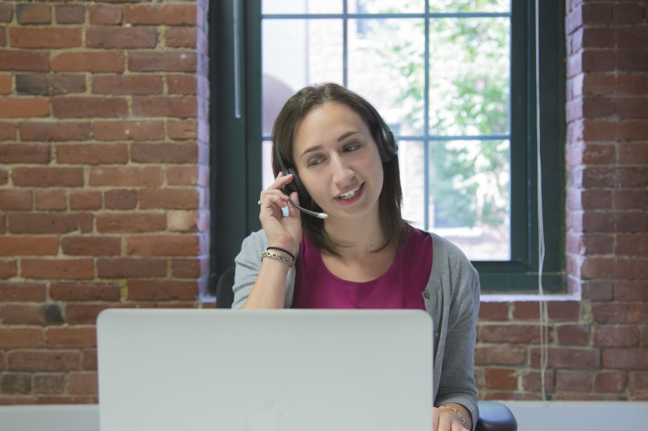 Woman working at a laptop delivering telemedicine for long-term care